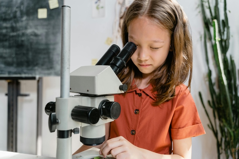 Girl using microscope